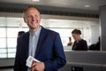 Businessman with passport and boarding pass at the airport Royalty Free Stock Photo