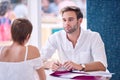 Businessman paying attention to his female partner during business meeting