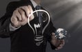 Businessman with a pen drawing light bulb Royalty Free Stock Photo