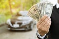 Businessman Person holding a wallet in the hands of take money out of pocket stand front car