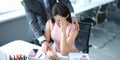 Businessman pestering female colleague in the workplace.