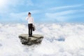 Businessman on the phone above clouds Royalty Free Stock Photo