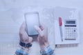 Businessman with a phone in his hands. Concept of global governance over the Internet. Office worker. Calculator and notepad Royalty Free Stock Photo