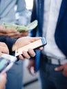 Businessman with a phone close-up on other businessmen with phones