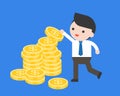 Businessman pick a coin from pile of coins, or arrange gold coin