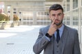 Businessman picking his nose in office space Royalty Free Stock Photo