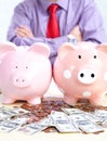 Businessman with a pig bank Royalty Free Stock Photo