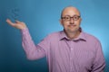 A businessman in a piked shirt holds a dollar sign in the hand Royalty Free Stock Photo