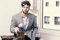 Businessman with pile of books and globe model on window background. Importance of knowledge concept. Cool guy wearing Royalty Free Stock Photo