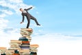 Businessman on pile of books Royalty Free Stock Photo
