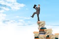 Businessman on pile of books Royalty Free Stock Photo