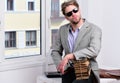 Businessman with pile of old books on office window background. Royalty Free Stock Photo