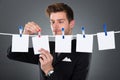 Businessman Pinning Blank Papers On Clothesline Royalty Free Stock Photo