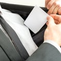 Businessman placing a blank business card in the inner pocket of Royalty Free Stock Photo