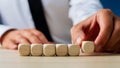 Businessman placing six blank wooden dices in a row Royalty Free Stock Photo