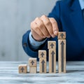 Businessman placing upward arrows on ascending blocks, symbolizing growth