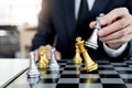 Businessman playing chess figure take a checkmate another king with team, strategy or management win or success concept