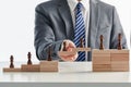 Businessman playing with chess figures and domino - the concept of success and growth Royalty Free Stock Photo