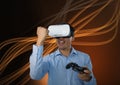 Businessman playing with computer game controller with virtual reality headset with curvy lines back Royalty Free Stock Photo