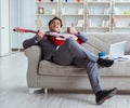 Businessman playing guitar at home Royalty Free Stock Photo