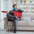 Businessman playing guitar at home Royalty Free Stock Photo