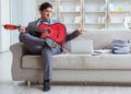 Businessman playing guitar at home Royalty Free Stock Photo