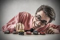 Businessman playing with little cars