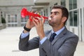 Businessman playing the trumpet isolated