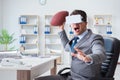 Businessman playing virtual reality football in office with VR g