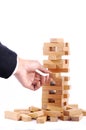 Businessman playing with the wood game (jenga). on white background