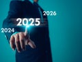 Businessman point finger at text 2025, Set goals for 2025, Implementation of business goals plan, Development to achieve goals
