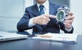 Businessman pointing at clock. Close-up photo