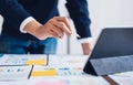 Businessman pointing digital pens to tablet and working on the table and financial documents in office.