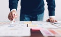 Businessman pointing digital pens and working on the table and financial documents in office. successful workplace strategy.