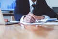 Businessman pointing on document, accounting financial business report and accountancy document with calculator on desk at office