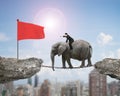 Businessman with pointing finger riding elephant toward red flag Royalty Free Stock Photo