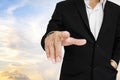 Businessman pointing finger to screen, sky background Royalty Free Stock Photo