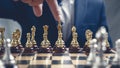 Businessman pointing his finger at a gold Chess King figure Royalty Free Stock Photo