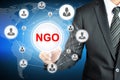 Businessman pointing on NGO (Non-Governmental Organization) sign on virtual screen Royalty Free Stock Photo