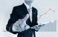 Businessman pointing raising graph on screen. Business growth, investment and finance concept