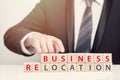 Businessman pointing at relocation inscription, relocation concept Royalty Free Stock Photo