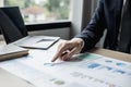 Businessman pointing to a pie chart on the document, he is examining the data from the finance documents Royalty Free Stock Photo