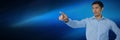 Businessman pointing touching air in front of blue background Royalty Free Stock Photo