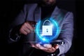 Businessman pointing and using mobile phone. Padlock and security icon for mobile internet use. Cybersecurity and privacy concept