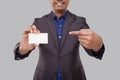Businessman Pointing at Visit Card Isolated Close Up. Indian Business man blank Card in Hand Royalty Free Stock Photo