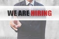 Businessman pointing word We are hiring