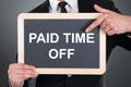 Business Man Pointing At Paid Time Off Text On Slate
