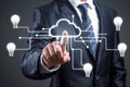 Businessman points to cloud with digital connections, evoking tech and innovation Royalty Free Stock Photo