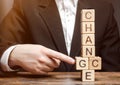 Businessman points to wooden blocks with the word Change to Chance. Personal development. Career growth or change yourself concept Royalty Free Stock Photo