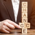 Businessman points to wooden blocks with the word Change to Chance. Personal development. Career growth or change yourself concept Royalty Free Stock Photo